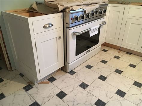 stove sticks out from cabinets